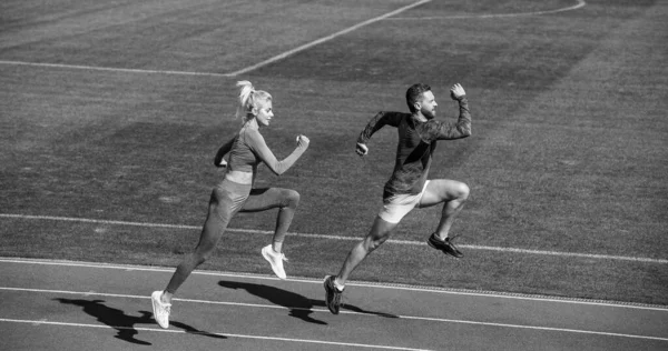 Atlético casal de velocistas correr em pista de corrida no estádio, sucesso — Fotografia de Stock