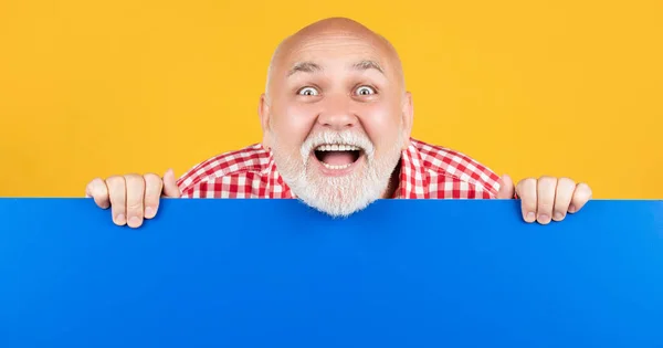 Amazed senior man with copy space on blank banner — Foto Stock
