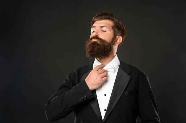 Brutal gentleman in tuxedo on black background, suit — Stock fotografie