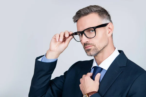 Empresário maduro em terno de negócios e óculos em fundo cinza. espaço de cópia — Fotografia de Stock