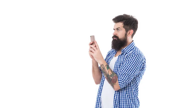 Surprised brutal bearded man taking picture with phone isolated on white background with copy space —  Fotos de Stock