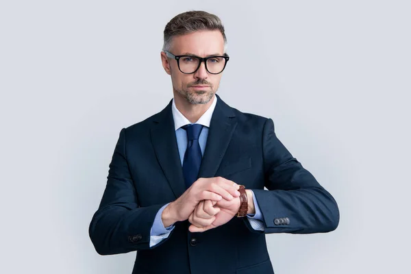 Mature ceo wear businesslike suit check time on wristwatch on grey background — Foto de Stock