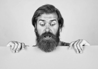 amazed bearded brutal man with moustache hold paper shit for copy space, information