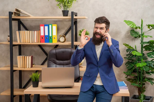Agreed on this. Happy man talk on cell phone in office. Agreed. Showing OK gesture to agree — Stock Photo, Image