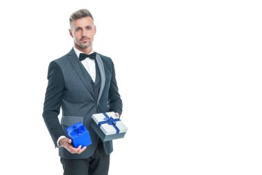 smiling businessman in tuxedo with box isolated on white. boxing day