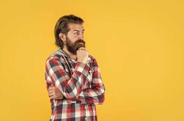 let me think. well groomed hairstyle. male beauty and fashion look. hipster checkered shirt for bearded guy. unshaven brutal man with beard. hairdresser concept. mature and confident