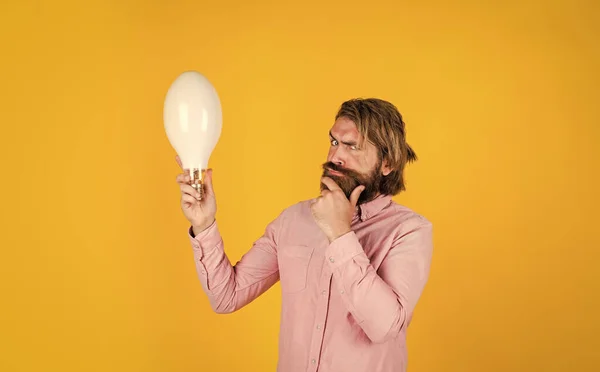 Let me think. male brain and logic. confident creative businessman. bearded man. creativity and inspiration. mature hipster with beard hold lamp. brutal caucasian hipster inspired with idea — Stock Photo, Image