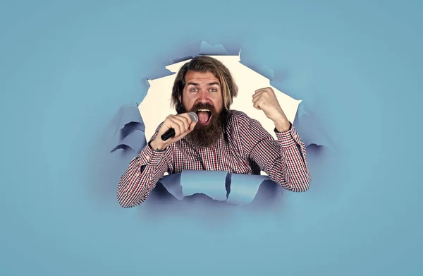 Announce the winner. brutal male hipster with microphone. vocal school. favorite music style. concept of music. performer having fun. mature bearded man on blue background sing song — Stock Photo, Image