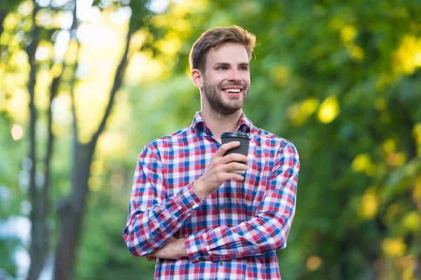 Cheerful young man in checkered shirt with coffee cup — Foto de Stock