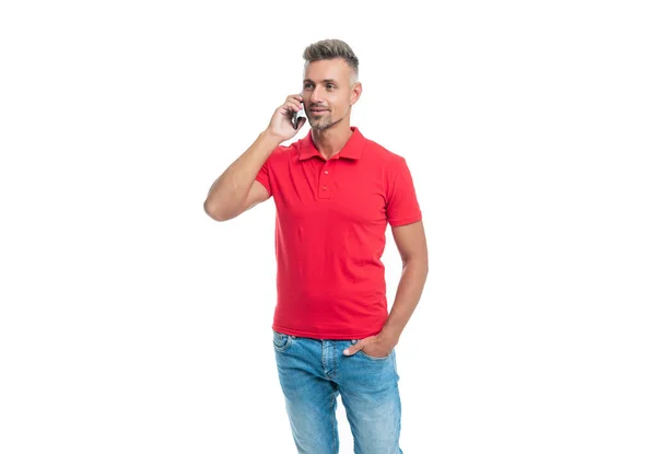 Man in red tshirt speaking on cell phone isolated on white background — Photo