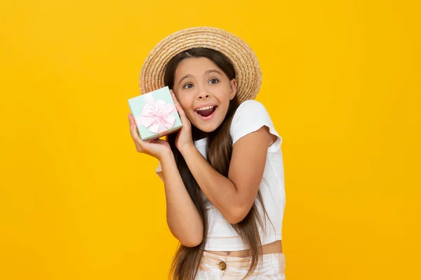 Happy teen kid hold present box on yellow background — Stock Fotó