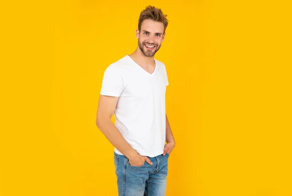Happy guy with bristle on yellow background, mens beauty — стоковое фото