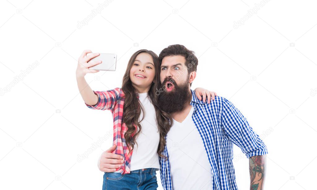 Funny selfie with dad. Girl child and bearded man take selfie with smartphone. Happy family