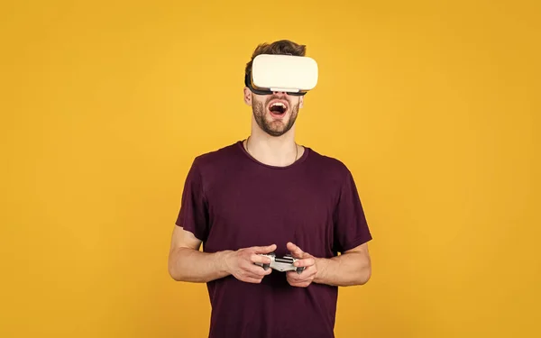 It is so real. playing virtual computer video game online. young man in vr glasses. new technology and innovations. male in wireless headset. guy use modern technology. digital future.