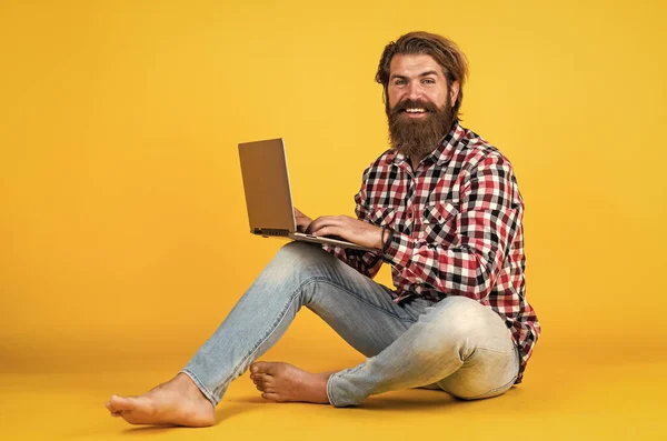 Attentive man with notebook. bearded guy in checkered shirt listens to online lecture. webinar and business training. using laptop. concept of online learning. Social distance.