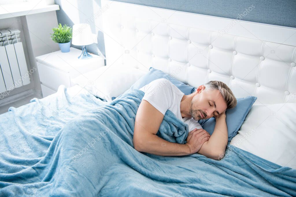 mature man sleeping in bed. sweet dreams.