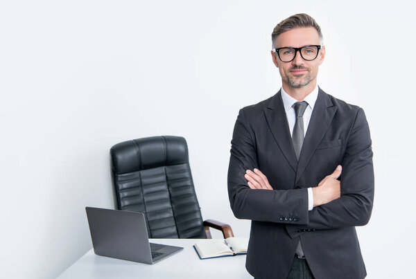 mature director wear suit and eyeglasses in boss office on white background.