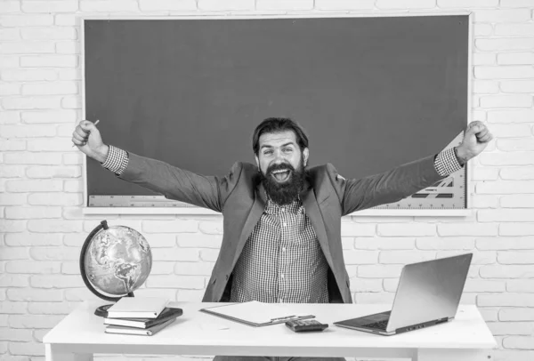 mature bearded man teacher in costume sit in school classroom with geography globe map, vacation.