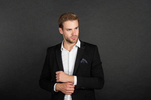 young man in jacket on black background, fashion.