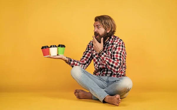 what taste is better. Handsome mature guy drinking from cup. Hold paper cup of coffee or tea. lifestyle concept. handsome hipster man with cup of take away coffee. he is taking coffee break.