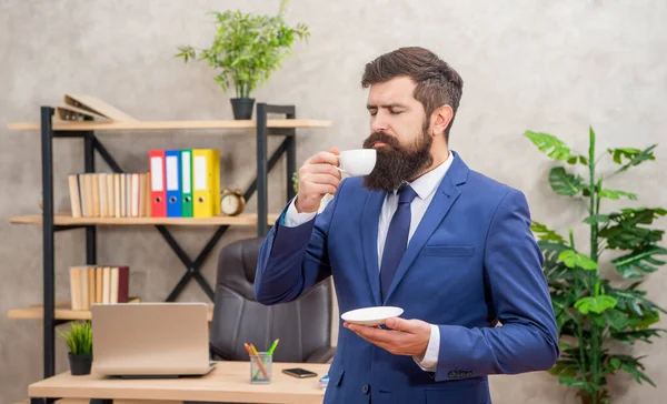 bearded businessman enjoy coffee in the office with copy space, guy.