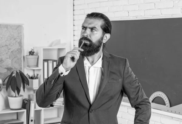 mature bearded man teacher in costume in school classroom with blackboard, teachers day.