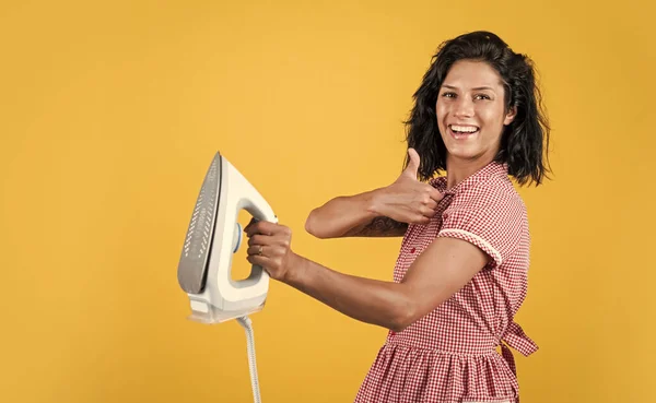 best quality. steaming iron. pinup girl prepare ironing. vintage lady hold modern iron. Everyday life housework. retro woman with iron. happy housekeeper ironing. concept of householding. copy space.