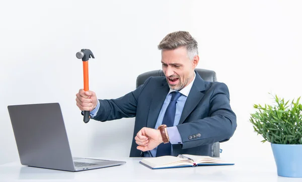 frustrated boss hitting laptop with hammer and check time.