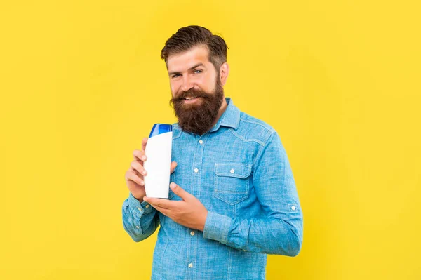 Brutal Bearded Man Hold Hair Conditioner Bottle Yellow Background Skincare — Foto Stock