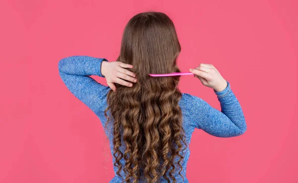 Back View Teen Girl Combing Curly Hair Hairbrush Pink Background — ストック写真