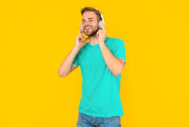 Müzik dinle. Kablosuz cihaz aksesuarı. Yeni teknoloji. Modern kulaklıklı mutlu adam. Online eğitim. Okula dönüyorum. Kulaklıklı genç adam. Müzik aşığı.