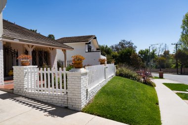 Private house suburban architecture with front yard and lawn in suburb.
