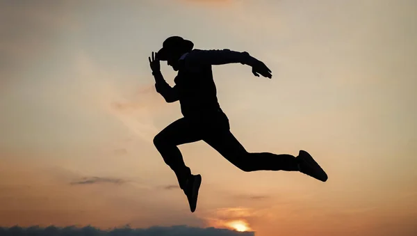 日の出の空を自由に走る男のシルエットスタミナ — ストック写真