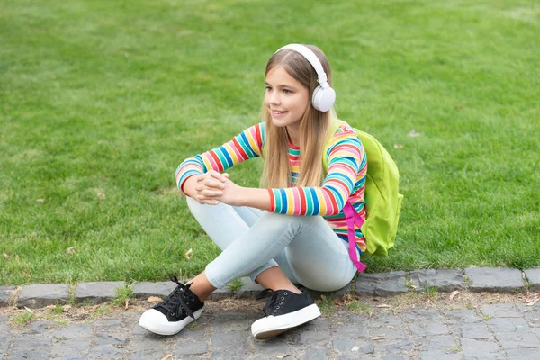 Happy Adolescent Girl Backpack Listening Music Sitting Grass Outdoors Education — Zdjęcie stockowe