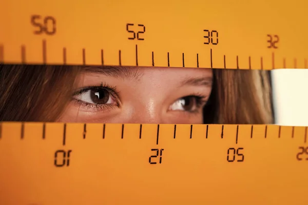 You Do The Math. measure the size. pupil kid study geometry. child learn math. college student do homework. measurement. eyes of girl with ruler. back to school. concept of education.