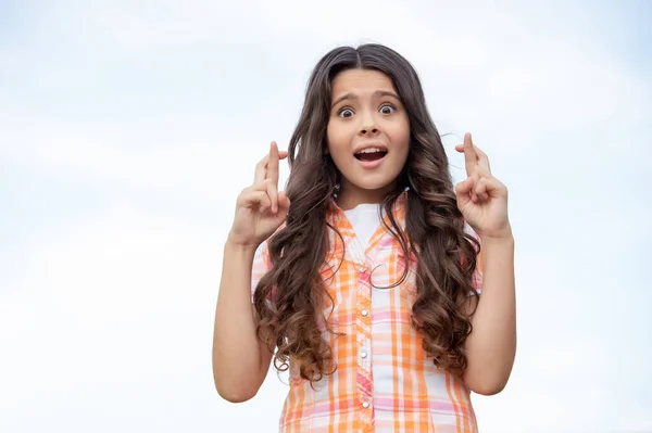 Terrified Teen Girl Keeping Fingers Crossed Sky Background Copy Space — Fotografia de Stock