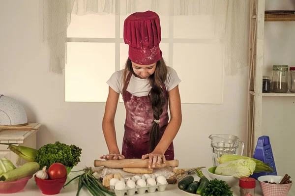 free healthy. kid chef cooking making dough. child prepare healthy food at home and wearing cook uniform. housekeeping and home helping. childhood development. small girl baking in kitchen.