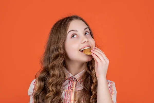 Θετική Έφηβος Κορίτσι Τρώει Μπισκότα Βρώμης Πορτοκαλί Φόντο — Φωτογραφία Αρχείου