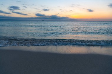 beautiful sundown with sea water on the summer beach.
