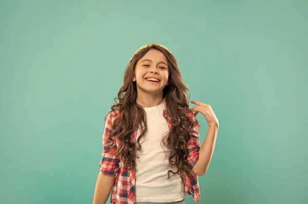 female fashion model. frizzy hair curl. girl has wavy hairdo. portrait of frizz child. express positive emotion. haircare and skincare. hairdresser. laughing kid with curly hair. teen beauty hairstyle