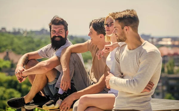 Free time. best friends. Summer vacation. happy men and girl relax. diverse young people talking together. group of four people. great fit for day off. Group of people in casual wear.
