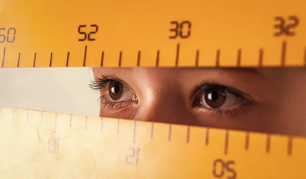 possibilities with Math are Infinite. eyes of girl with ruler. back to school. education. measure the size. pupil kid study geometry. child learn math. college student do homework. measurement.