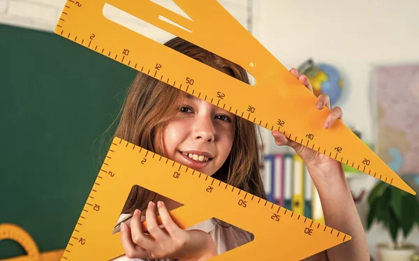 child learn mathematics. college student do homework. teen girl with triangle ruler. back to school. concept of education. measuring angle degree. pupil kid study trigonometry.