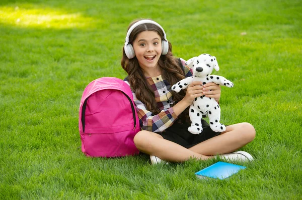Surprised Teen Girl Listening Music Holding Dog Toy Grass School — Foto Stock
