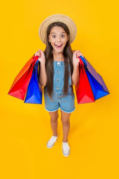Surprised Teen Child Shopping Bags Yellow Background Full Length — Zdjęcie stockowe