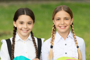 schoolgirl portrait. two smiling teen children schoolgirls outdoor. friendship of schoolgirls.