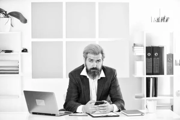 bearded man in jacket with laptop. boss in workplace. modern office life. distant work while coronavirus quarantine. mature school teacher. business-minded businessman.