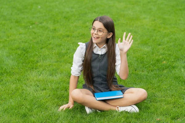 Happy Teenage School Girl Waving Hand Sitting Grass Hello School — 스톡 사진