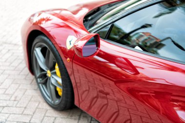 Miami Beach, Florida USA - April 18, 2021: car side mirror of red Ferrari.