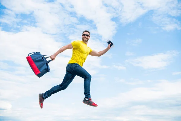 Energetic Man Running Travel Bag Midair Sky Background Vacation — стоковое фото